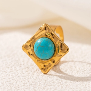 Macro shot of 18K gold plated stainless steel ring with turquoise stone and hammered texture