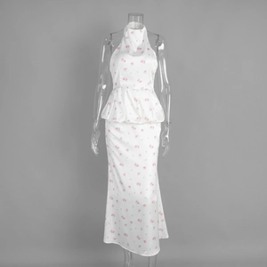 Detail of floral halter neck long dress featuring ruffled waist and floor-length skirt