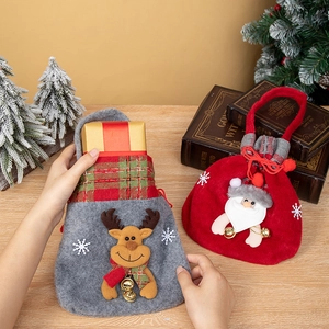 Detail showing red Santa Claus drawstring gift bag with 3D decor and golden bells