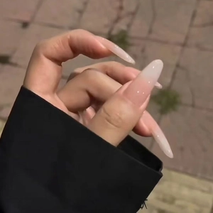 Glossy long almond press-on nails with soft nude pink to milky white gradient finish