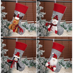 Set of four festive Christmas stockings with reindeer, snowman, penguin and Santa designs