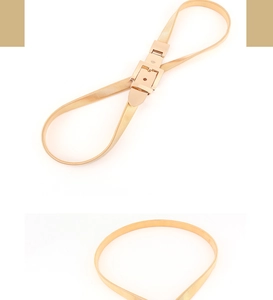 Detail of gold metal spring waist belt featuring a rectangular buckle and sleek snake chain