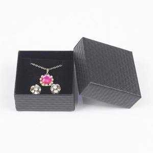 Detail of jewelry set with pink gemstone necklace and earrings in a black gift box