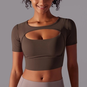 Front detail of dark brown workout crop top with crescent cutout and crew neckline