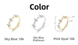 Macro detail of adjustable flower ring with sky blue gemstone and pink opal on gold brass
