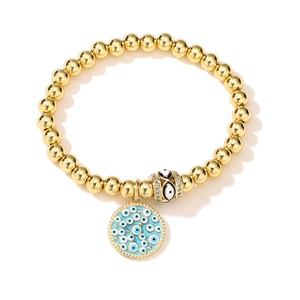 Close-up of 18K gold plated evil eye beaded bracelet with blue enamel charm and gems