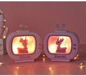 Detail of pink and purple vintage TV night lights with sweet glowing deer figurines