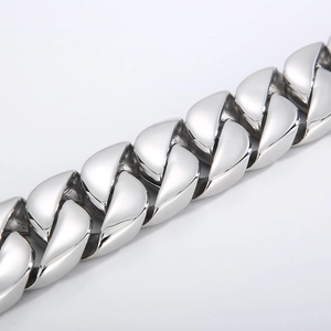 Macro shot of polished silver stainless steel Cuban chain showing thick metal link detail