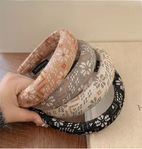 Detail of four handmade knitted flower headbands in assorted colors for winter