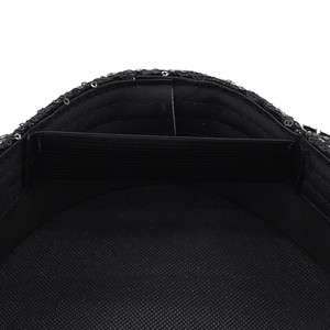 Detail view of the black sequin party hat featuring soft lining and elastic inner band