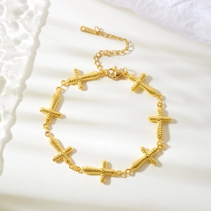 Elegant gold stainless steel bracelet featuring interlocking cross charms and adjustable clasp