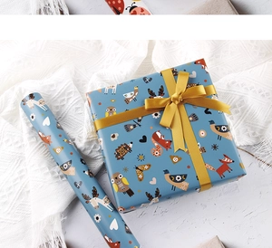 Detail of Nordic cartoon forest animal gift wrapping paper with blue roll and gold ribbon