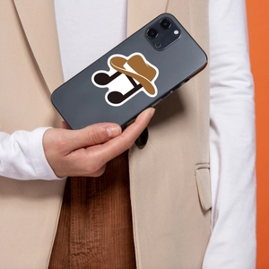 Detail of Western cowboy hat music note sticker on the back of a grey smartphone