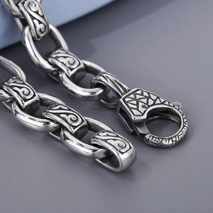 Vintage silver stainless steel chain bracelet with intricate engraved geometric patterns