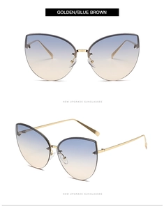 Close-up of golden cat-eye sunglasses with blue brown gradient lenses and metal frame