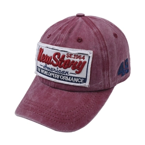 Vintage burgundy baseball cap with retro lettering patches and washed cotton texture