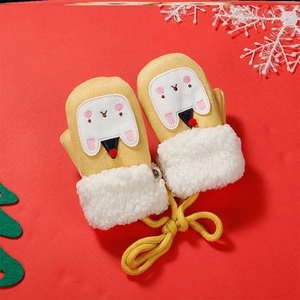 Detail of yellow baby mittens with plush white trim and cute cartoon rabbit accents
