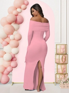 Back view of elegant pink off-shoulder maternity evening dress featuring a stylish slit