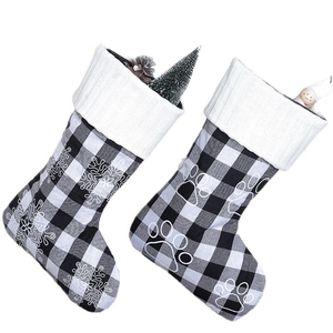 Pair of 18-inch plaid Christmas stockings with white snowflake and paw print patterns
