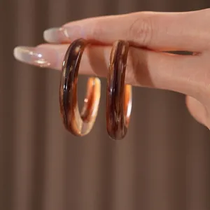 Brown tortoiseshell resin C-shaped hoop earrings with elegant Maillard style finish