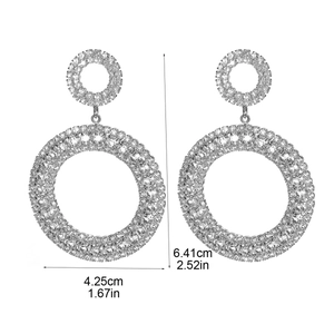 Détail montrant les dimensions des boucles d'oreilles strass géantes 6,41cm sur 4,25cm