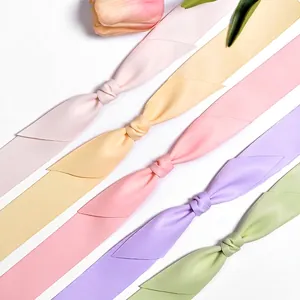 Silky satin ribbon assortment in pastel pink yellow and green for gift wrapping DIY