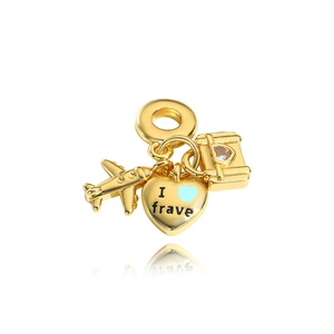 Detail view of gold charm set with airplane, heart, and crystal suitcase pendants