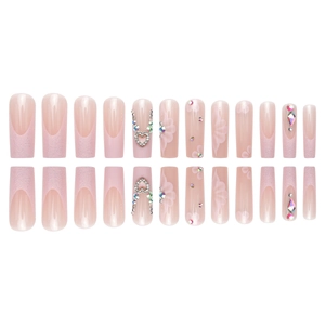 French gradient press-on nails with pink flower petals and heart crystal rhinestones