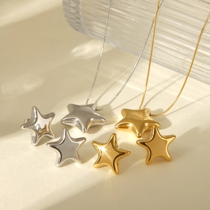 Macro shot of minimalist 18K gold and silver star pendant necklace and stud earrings set