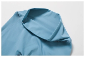 Detailed close-up of high-waist yoga pants waistband with seamless sky blue stitching