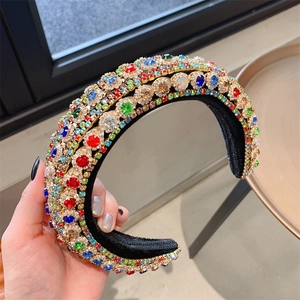 Close-up of luxury Baroque headband with multicolored rhinestones on a gold base