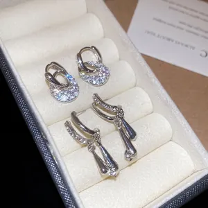 Set of sparkling cubic zirconia C-shape hoop earrings and teardrop tassel pendants
