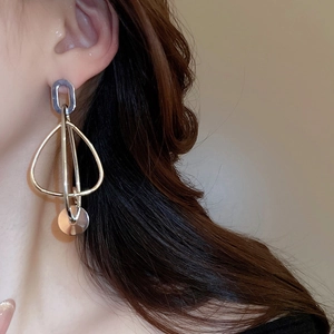 Vue latérale macro d'un mannequin portant des boucles d'oreilles argentées épurées