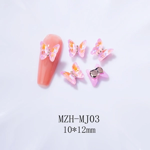 Macro shot of 10x12mm Aurora crystal butterfly nail charms with metallic bead accents