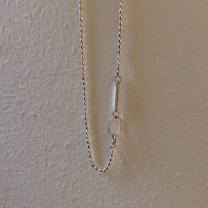 S925 sterling silver ball chain necklace with engraved bar pendant on textured wall