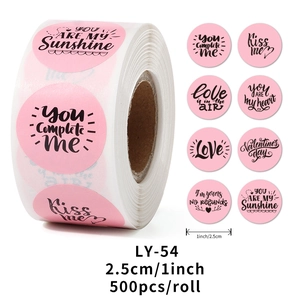 Detail view of pink Valentine stickers roll with romantic quotes and heart designs