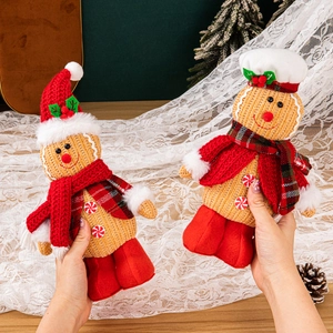 Set of two standing gingerbread man dolls with red hats and scarves for Christmas decor