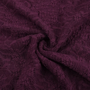 Detailed macro view of deep purple floral lace fabric with intricate crochet patterns