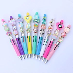 Close-up of DIY colorful beaded ballpoint pens with cute resin charms in a fan layout