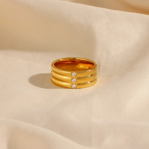 Macro view of 18K gold plated stainless steel triple band ring with three cubic zirconias