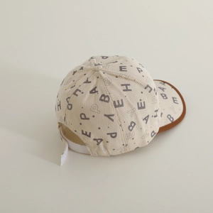 Detail of baby corduroy baseball cap with letter print and adjustable velcro strap
