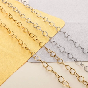 Detailed macro view of textured gold and silver link chains for DIY jewelry making