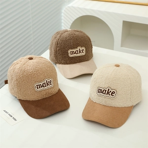 Macro detail of plush sherpa and corduroy patchwork baseball caps with make patches