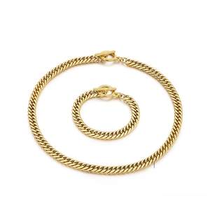 Detail of gold stainless steel curb link necklace and bracelet set with T-bar toggle clasp