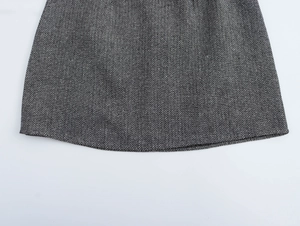 Close-up of grey and black herringbone fabric texture with detailed stitching finish