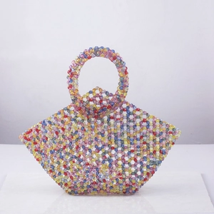 Handmade multicolored beaded tote bag with a circular handle in a vintage woven style