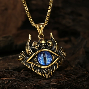 Close-up of vintage punk necklace with blue evil eye pendant and golden skulls