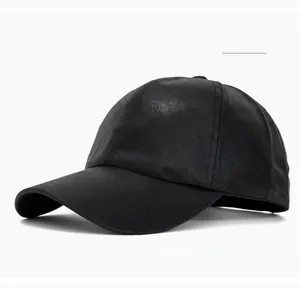 Close-up of black baseball cap with six-panel structure and curved brim detail