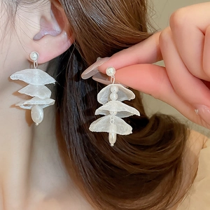 Elegant white lace flower earrings with pearls shown on model for a graceful summer look