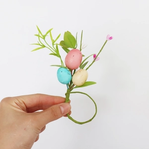 Easter egg napkin ring with colorful speckled eggs and realistic green foliage decor